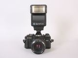 a black camera with a flash light on top of it
