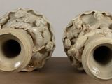 two vases that are sitting on a table