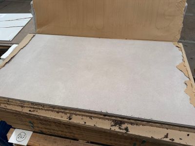 a cardboard box sitting on top of a pallet of wood