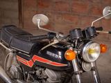 a motorcycle that is parked in front of a brick wall