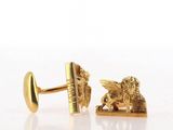 pair of gold tone cufflinks with a lion and a book