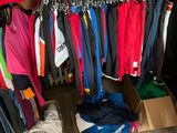 a closet full of clothing and shoes in a store