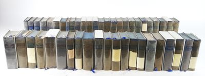a lot of books stacked on top of each other