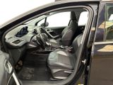 the interior of a car with the door open and the driver ' s seat down
