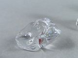 two clear glass figurines of elephants on a table