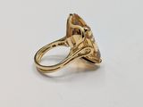 a yellow gold ring with a faceted citrine stone in the center