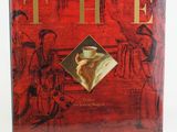 a book with a red cover and gold lettering on it