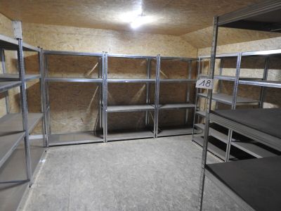 a room with a lot of shelves and shelves in it