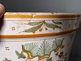 a person holding a large bowl with flowers on it