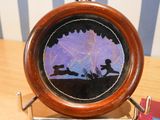 a wooden clock with a picture of a boy and a dog on it