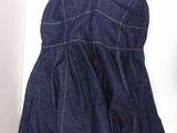 a picture of a denim dress hanging on a wall