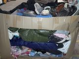 a cardboard box full of clothes in a warehouse