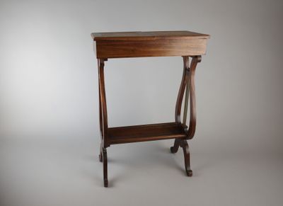 a small wooden table with a magazine rack on it