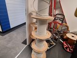 a man standing next to a stack of wires on the floor