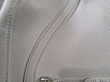 an image of a white purse with a metal buckle