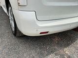 a white car that is parked on the side of the road