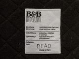 the label on the back of a black quilted jacket