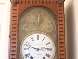 a grandfather clock with roman numerals on the face