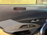 a close up of a car door handle with a sticker on it
