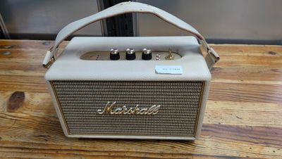 an image of a small white speaker sitting on top of a wooden table
