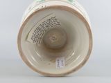 underside view of a porcelain vase with a label on it