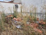 a pile of bricks sitting in the grass next to a building