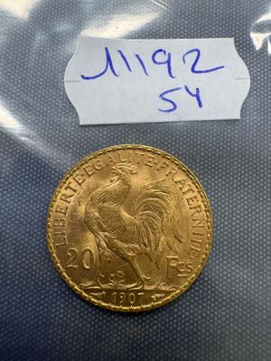 a close up of a gold coin with a label on it