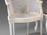 pair of white cane chairs and a stool in the style of louis ii