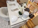 a table with two sinks and a vase of flowers on it