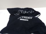 two black sweatshirts with white logos on them sitting on a white surface