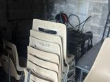 many chairs in a room with a table and chairs