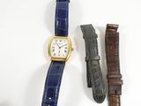 two watches are sitting next to each other on a white surface