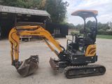 an image of a small excavator parked in a parking lot