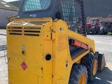 a yellow construction vehicle parked in a parking lot