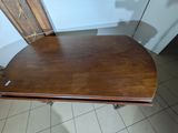 a small table with a wooden top on a tile floor