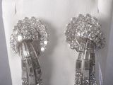 pair of diamond and white gold earrings on a mannequin display