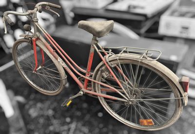a red bicycle that is hanging from a wire