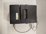 a black device that is connected to a charger