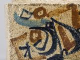 a close up of a vase with a bird on it