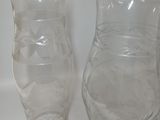 three glass vases sitting on a white surface