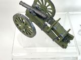 a small model of a cannon on display in a glass case