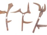 three old tools are sitting next to each other on a white surface