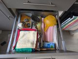 a kitchen drawer that has a lot of items in it