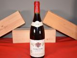 a bottle of wine sitting on a table next to a wooden box