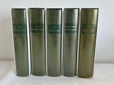 four books are lined up in a row on a white surface
