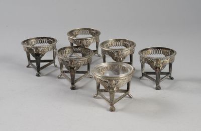 six silverplated cups and saucers on stands