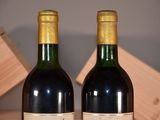 two bottles of wine sitting next to each other on a table