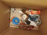 a cardboard box filled with tools and other items