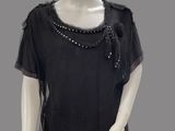 an image of a mannequin wearing a black top and black leggings