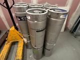 plusieurs fûts de bière posés sur une palette dans une pièce